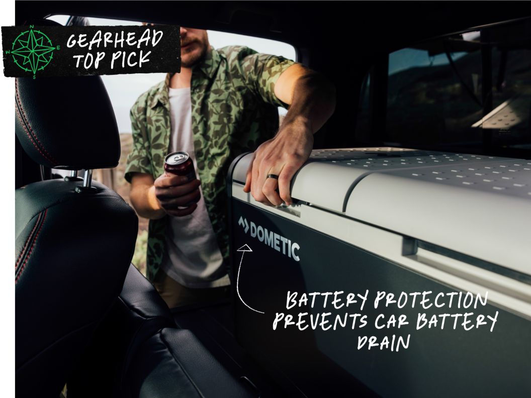 A man gets ready to open a cooler inside a car. Text overlay reads: Gearhead Top Pick, battery protection prevents car battery drain.